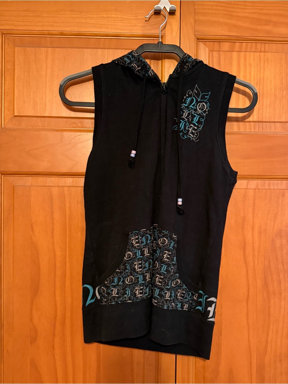 Nollie Black Sleeveless Zip Hoodie with Teal Graphic Accents